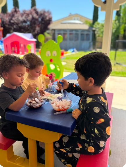 Children doing water science experiments at Fairy Tale Child Care